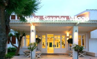 "the entrance to a hotel with a sign that reads "" hotel simpleter village "" in front of it" at Skopelos Village Hotel