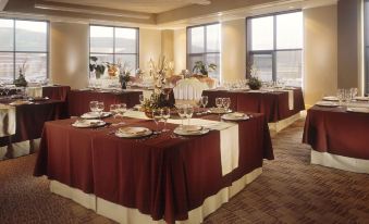 a large dining room with multiple tables set for a formal event , possibly a wedding reception at Newpark Resort