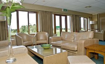 a living room with multiple couches and chairs arranged around a coffee table , creating a cozy atmosphere at Best Western Preston Garstang Country Hotel and Golf Club