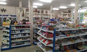 a well - stocked supermarket with shelves filled with various products , including food items and beverages , in a well - lit room at Baiboon Resort