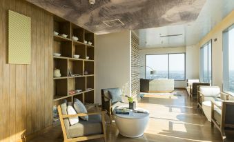 a modern living room with wooden floors , a fireplace , and a bookshelf filled with books at Alila Solo