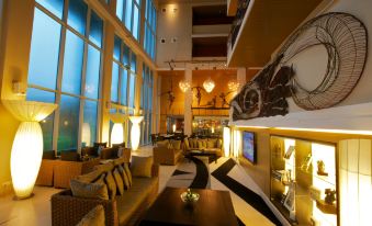 a large , well - lit room with multiple couches and chairs arranged in a comfortable seating area at Radisson Blu Anchorage Hotel