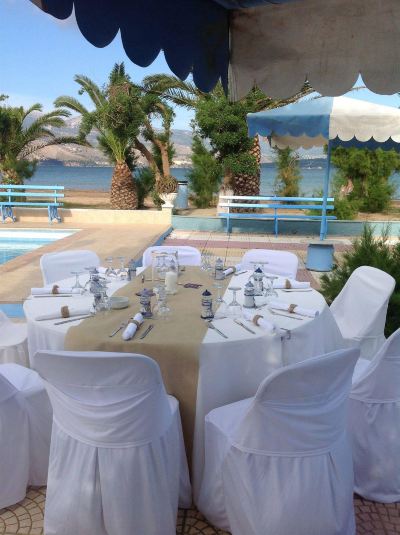 a large outdoor dining area with tables and chairs set up for a party , possibly a wedding reception at Hotel Summery
