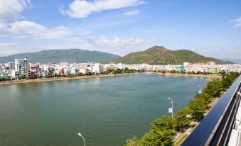 a large body of water with mountains in the background , creating a picturesque view at Lake View Hotel