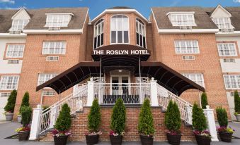 "a brick building with a sign that reads "" the roslyn hotel "" prominently displayed on the front of the building" at The Roslyn, Tapestry Collection by Hilton