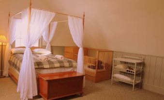 a bedroom with two beds , one of which is a canopy bed and the other a bunk bed at Cobb Hill Estate
