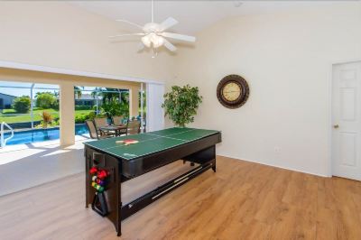 a game room with a pool table , a foosball table , and a television mounted on the wall at Italy