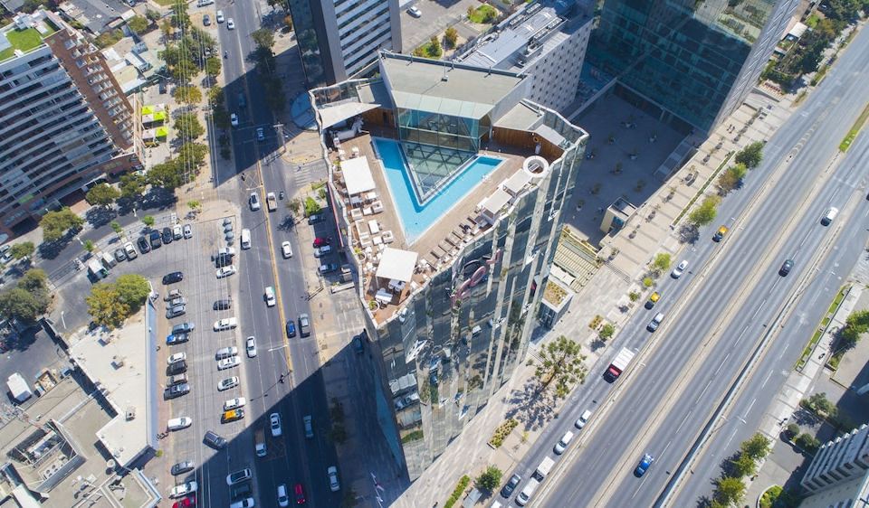 a bird 's eye view of a modern building with a pool and city streets in the background at Icon Hotel