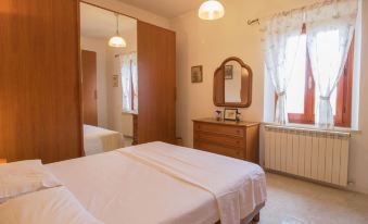 a clean and well - organized bedroom with two beds , one on each side of the room at Olimpia