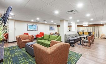 a room with several couches and chairs arranged in a lounge - like setting , possibly for a party or gathering at Grayson Manor