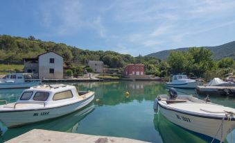 a body of water with several boats docked , including a boat and a smaller boat at Villa Mare