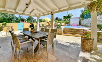 a large outdoor patio with a dining table and chairs set up for a meal at Villa Mare