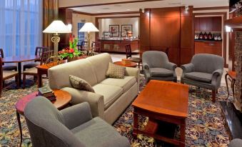 a cozy living room with various seating options , including couches , chairs , and a coffee table at Staybridge Suites Philadelphia Valley Forge 422
