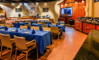 a large dining room with multiple tables and chairs , all set up for a party or event at Berjaya Beau Vallon Bay Resort & Casino