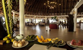 a large dining room with multiple tables and chairs arranged for a group of people to enjoy a meal together at VOI Amarina Resort