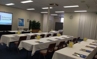 a conference room set up for a meeting , with several chairs arranged in rows and a podium at the front at Quality Hotel Robertson Gardens