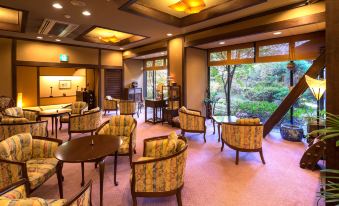 a spacious room with multiple chairs and couches arranged in various positions , creating a cozy and inviting atmosphere at Miyako