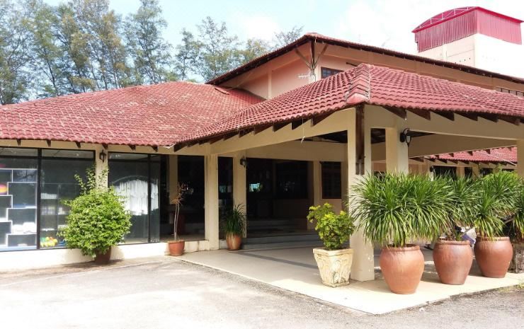 There is another building with two large windows and a front entrance on one side at Sudara Beach Resort