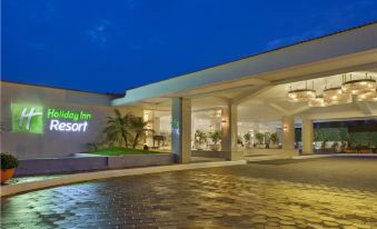 "a hotel entrance with a large sign that reads "" holiday inn resort "" prominently displayed on the building" at Holiday Inn Resort Goa