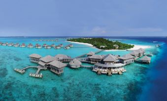 a bird 's eye view of a large tropical island with several buildings and water at Six Senses Laamu