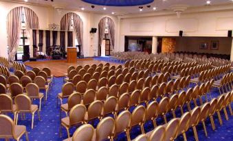 a large room with rows of chairs arranged in a semicircle , possibly for a conference or event at Park