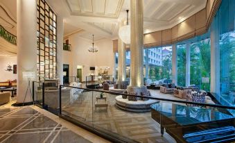 a luxurious hotel lobby with high ceilings , marble floors , and large windows that offer views of the outdoors at Meliá Purosani