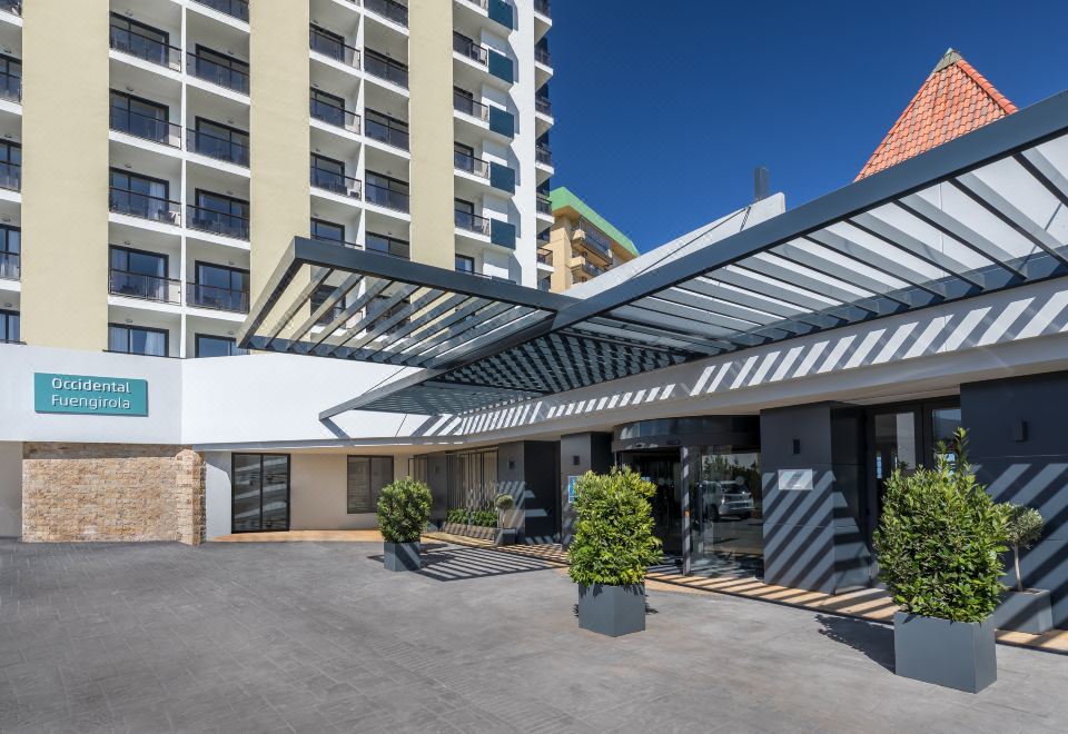 a modern building with a large glass roof , providing shade and protection from the elements at Occidental Fuengirola