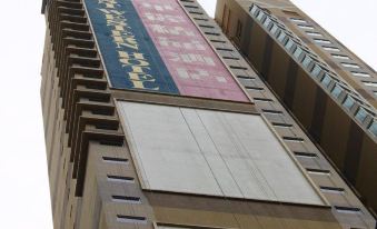"There is a tall building with a sign that says ""hotel"" on its side and another sign above it" at Best Western Hotel Causeway Bay
