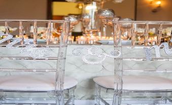 a dining table with two chairs , one on the left and one on the right , placed next to each other at Juniper Hotel Cupertino, Curio Collection by Hilton