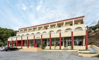 a large , modern building with red and white accents , situated in a sunny outdoor area at Belvedere Hotel