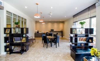 a modern hotel lobby with various seating options , including couches and chairs , as well as a dining table at Fortune D Hotel Loei