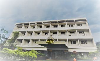 "a large building with a sign that reads "" sugon hotel "" prominently displayed on the front of the building" at Hotel Sangam