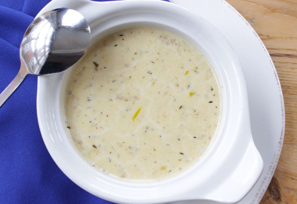 a white bowl filled with a creamy soup , accompanied by a spoon and a fork at Sheraton Portsmouth Harborside Hotel