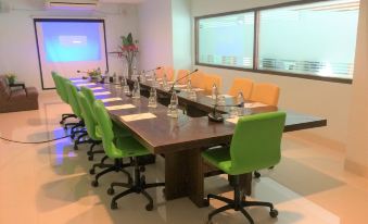 a large conference room with a long wooden table , multiple chairs , and various office supplies at Siam Triangle Hotel