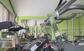 a room filled with various exercise equipment , including treadmills , stationary bikes , and weightlifting machines at Marsh House Farm
