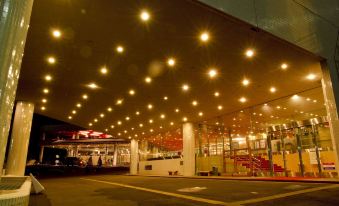 a bus station at night , with numerous lights illuminating the area and creating a warm and inviting atmosphere at Naeba Prince Hotel