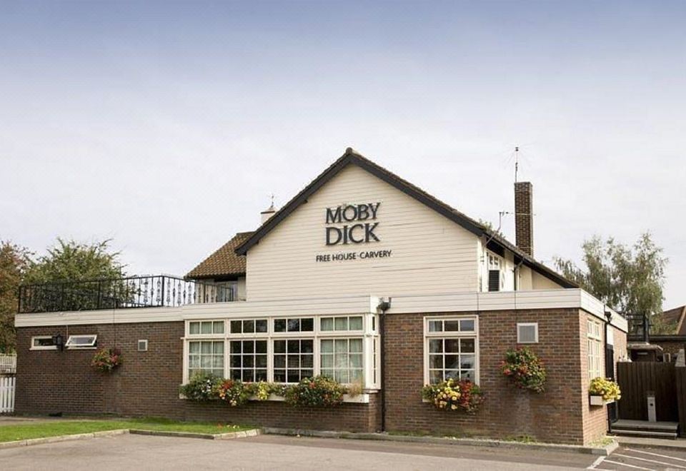 "a large brick building with a sign that reads "" moby dick inn & steakhouse "" on it" at Premier Inn London Romford West