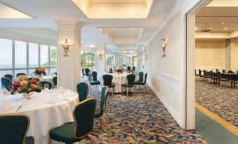 a large , well - decorated dining room with multiple tables and chairs set up for a formal event at Reefhouse Resort and Marina