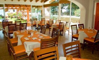 an outdoor dining area at a restaurant , with tables and chairs set up for guests to enjoy their meals at El Chante Spa Hotel