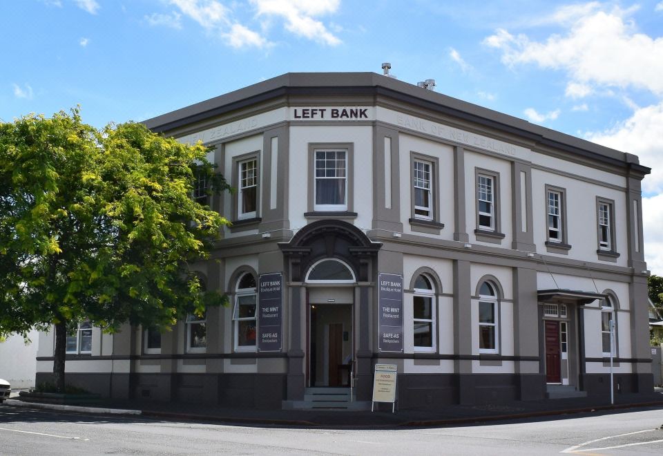 a brick building with a large sign on the front , possibly a bank or a building at Left Bank