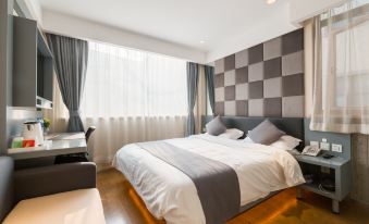 The contemporary bedroom features a double bed with a white headboard and large windows at Zhotels (Shanghai West Nanjing Road Westgate Mall)