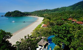 aerial view of a beach with a pool surrounded by lush green trees and a body of water at Pimalai Resort & Spa