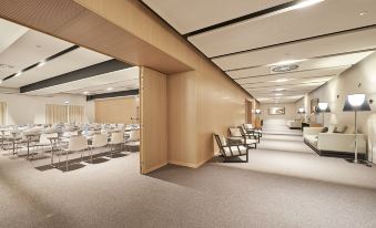 a large , empty conference room with multiple rows of chairs arranged in a semicircle around a podium at Cascade Wellness Resort