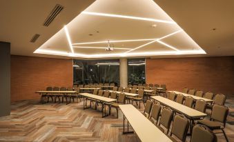 a large conference room with rows of tables and chairs arranged for a meeting or event at Four Points by Sheraton Puebla