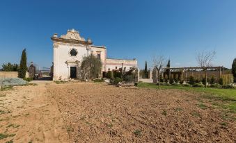 A large building with an old church in the background and another house on top is visible at Casino Doxi Stracca by BarbarHouse