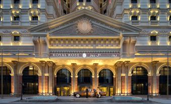 the royal rose hotel in shanghai , china , with its grand entrance and modern architecture illuminated at night at Royal Rose Abu Dhabi
