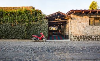 "a red scooter is parked in front of a building with a sign that reads "" selina ""." at Socialtel Atitlan - Formerly Selina Atitlan