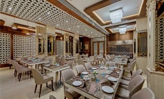a large dining room with multiple tables and chairs arranged for a group of people to enjoy a meal together at The Fern Residency Aurangabad