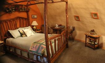 a cozy bedroom with a wooden four - poster bed in the center of the room , surrounded by various pieces of furniture and decorations at Thyme for Bed