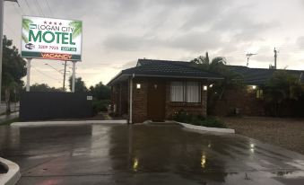 a motel with a sign on the front , located in a residential area near a road at Logan City Motor Inn